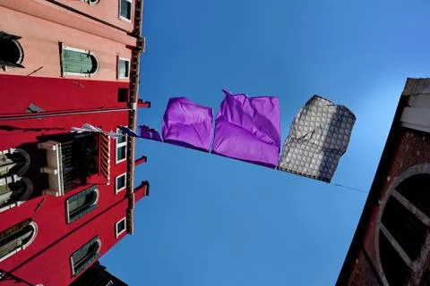 Sheets waving, spread between two buildings Stock Photos