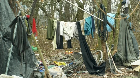 Sheets wood plastic foil chalet building homeless, drying clothes cord, t-shirts Stock Footage 102123388