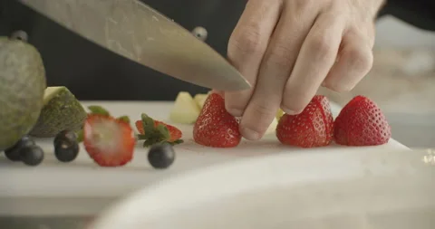 Сhef cuts strawberries in half with sharp knife. 4k slow motion video Stock Footage 103583914