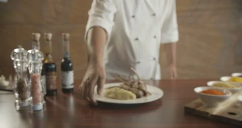 Сhef is spinning plate. Beef ribs, potatoes, asparagus and tomatoes. Video in Stock Footage 103950803