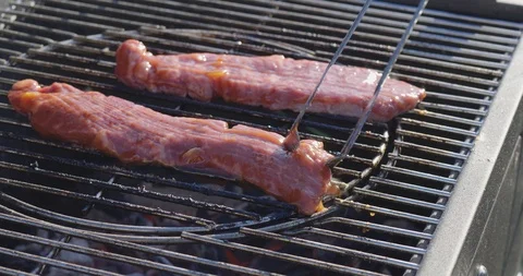 Сhef turns grilled meat Stock Footage 107325853