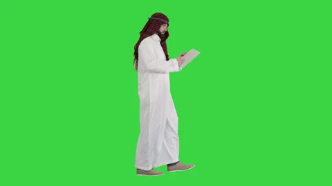 Sheikh presenting information or product using digital tablet on a Green Screen Stock Footage 137413355