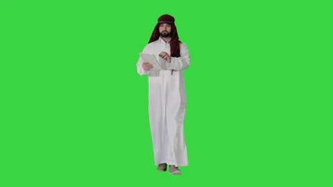 Sheikh presenting information or product using digital tablet on a Green Screen Stock Footage 141354678