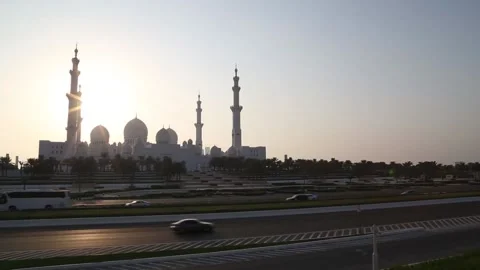 The Sheikh Zayed Grand Mosque across the road and a beautiful sunset view Stock Footage 132182974