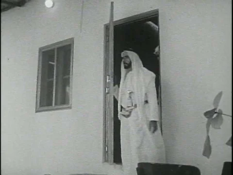 Sheikh Zayed leads a procession through the courtyard of his Abu Dhabi palace Stock Footage 75758886