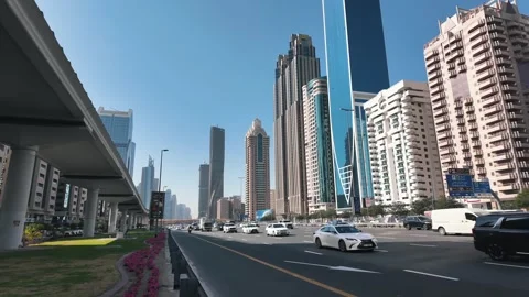 Sheikh Zayed Road in Dubai, bustling with traffic and framed by iconic Stock Footage 298307248