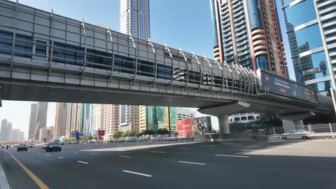 Sheikh Zayed Road in Dubai, bustling with traffic and framed by iconic Stock Footage 298307262
