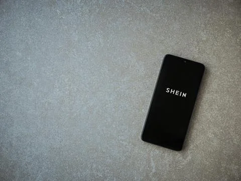 Shein app launch screen on smartphone on ceramic stone background Stock Photos