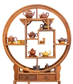 Shelf and ceramic teapots, cups, and other attributes for a traditional tea Stock Photos