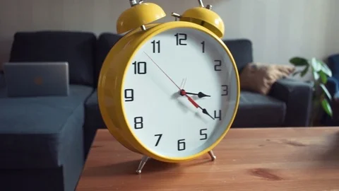 Shelf with big yellow clock and stack of books. Dolly shot Stock Footage 80814679