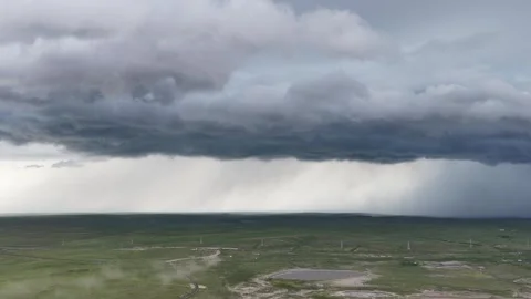 Shelf cloud and rain curtain over grassland power lines in Hulunbuir, China Stock Footage 341845116