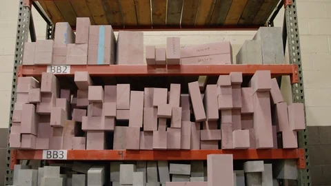 Shelf filled with rectangular pink foam ready to be carved Stock Footage 125179049