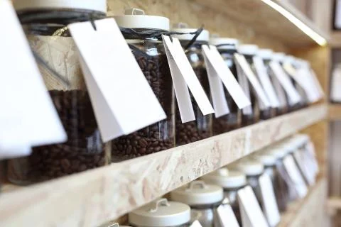 Shelf with jars of coffee beans 스톡 사진
