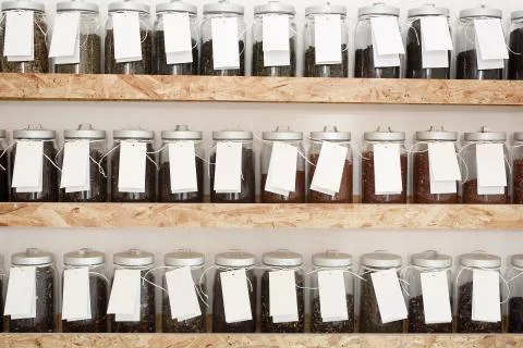 Shelf with jars of coffee beans Stock Photos