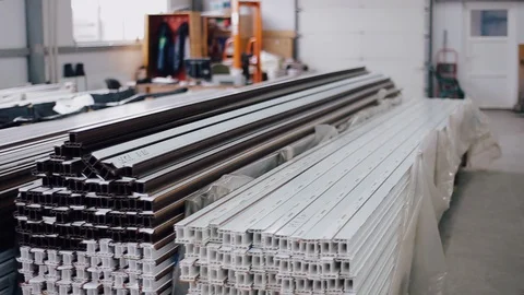 Shelf with profile blanks for the production of plastic windows. Vídeo Stock 129383797