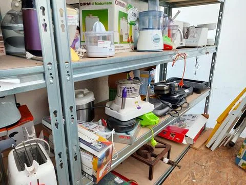 Shelf with second-hand appliances inside a store Stock Photos
