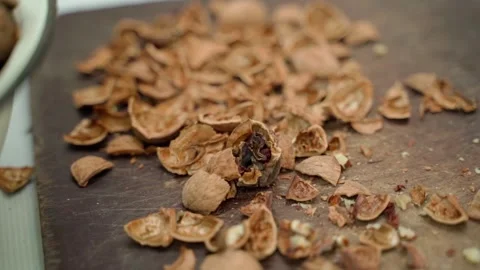 Shell after peeling a walnut on a wooden board, smooth parallax Stock-Footage 235680856