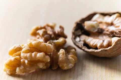In-shell and shelled walnuts. Production and consumption of walnuts. Stock Photos