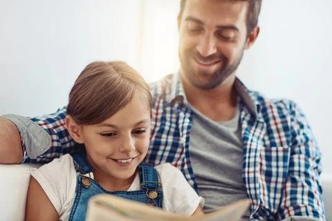 Shell be just as intelligent as her Dad. an adorable little girl spending time Stock Photos