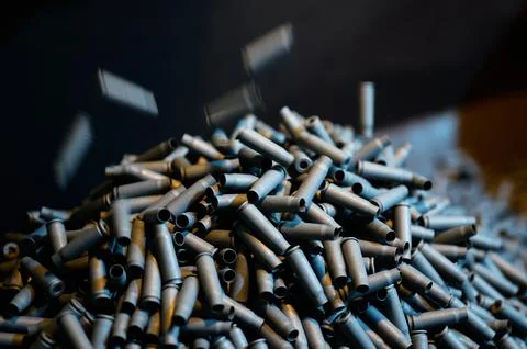 Shell casings fall down in ammunition production workshop Stock Photos