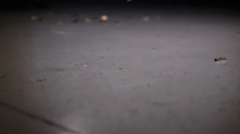 Shell casings from firing weapon bouncing off floor in slow motion - 2 clips Stock Footage 37584781