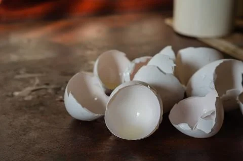 A shell of chicken eggs on a dirty kitchen table. Stock Photos