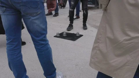 The shell game, also known as thimblerig or three shells and a pea in paris Stock Footage 248411696