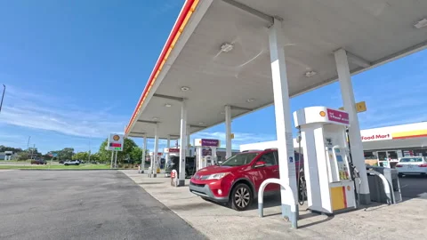 Shell gas station and convenience store pan around blue sky day Stockbeeldmateriaal 344274636
