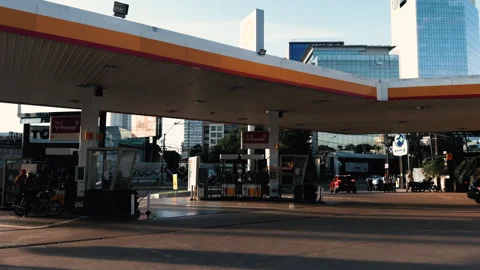 Shell gas station with fuel pumps and cars in urban setting Stock Footage 334593413
