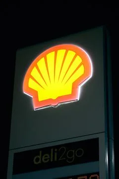Shell logo glowing at night close-up Stock Photos