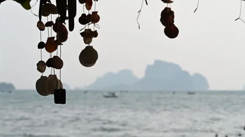 Shell ornaments hang above sea at Ao Nang Beach Stock Footage 333041709