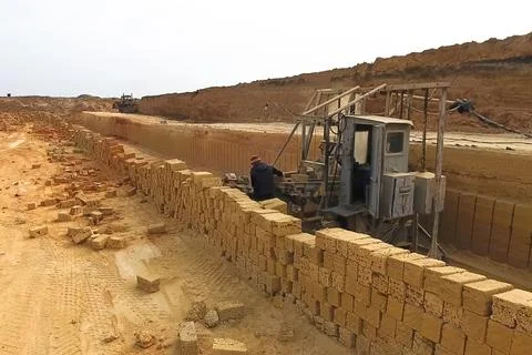 Shell quarry quarry. Cutting seashell into blocks right away in a quarry. Stock Photos