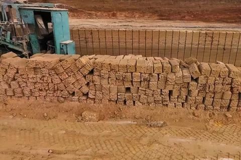 Shell quarry quarry. Cutting seashell into blocks right away in a quarry. Stock Photos