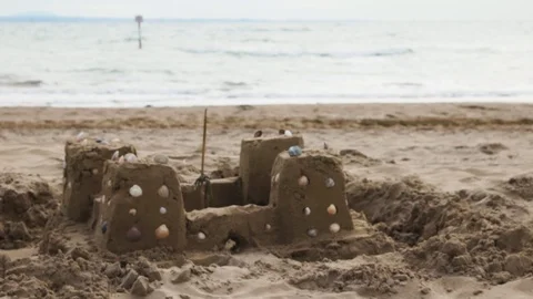 Shell on a Sandcastle On Ocean Beach Stock Footage 117410176