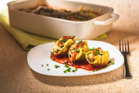 Shell-shaped pasta stuffed with spinach and cheese Stock Photos