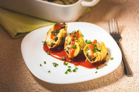 Shell-shaped pasta stuffed with spinach and cheese Stock Photos