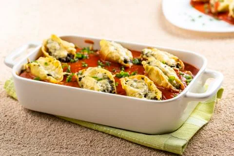 Shell-shaped pasta stuffed with spinach and cheese Stock Photos