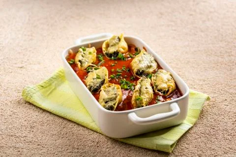 Shell-shaped pasta stuffed with spinach and cheese Stock Photos