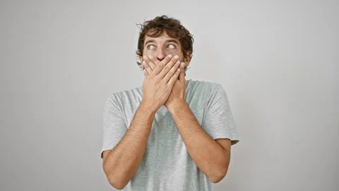 Shell-shocked young man covers mouth with hands in dismay over mistake. sec.. Stock Footage 261386380