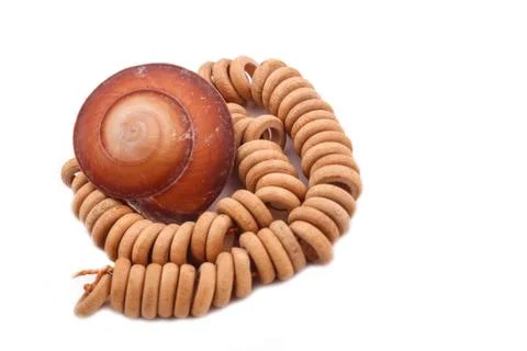 Shell with wood beads on the white background Stock Photos