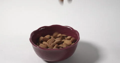 Shelled almonds dry fruit falling in a bowl Stock-Footage 310950191