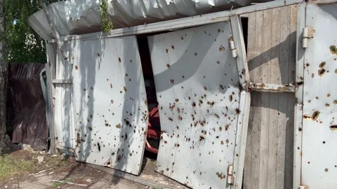 Shelled garage with car inside. War in Ukraine. Fighting marks. Stock Footage 236402161