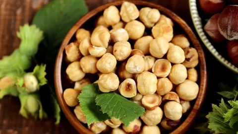 Shelled  hazelnuts set in round plates.Healthy fats.View from above. Stock Footage 263246709