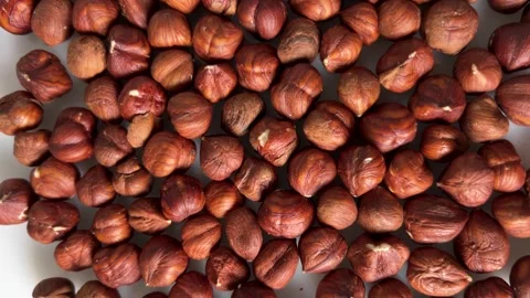 Shelled hazelnuts on a white background Video stock 326243871