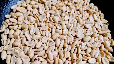 Shelled Peanuts in Black Textured Pan Top Down View Stock Footage 320419764