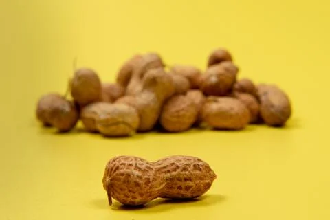 Shelled peanuts on yellow background Stock Photos