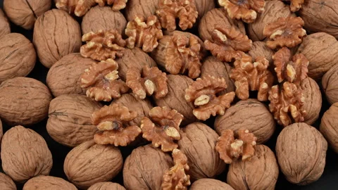 Shelled Walnut Kernels On Whole Walnuts In Shell Background Stockbeeldmateriaal 332529126