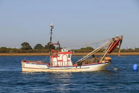 Shellfish boat moored at sunset in Punta Umbria bay, Huelva, Spain Stock Photos