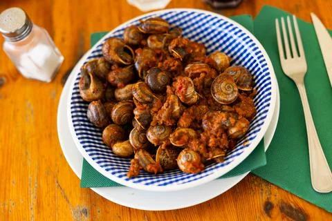 Shellfish snail cooked with minced meat and tomato dressing Stock Photos