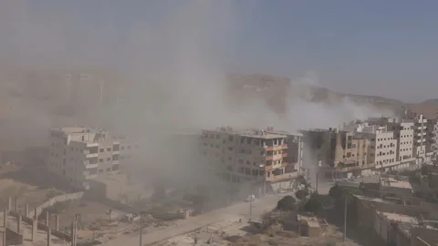 The shelling of the building of a large-caliber machine gun in Aleppo Syria Stock-Footage 169239813